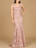 A sleeveless mermaid lace embroidered gown with a v-neckline, in a blush color, with a  train.
