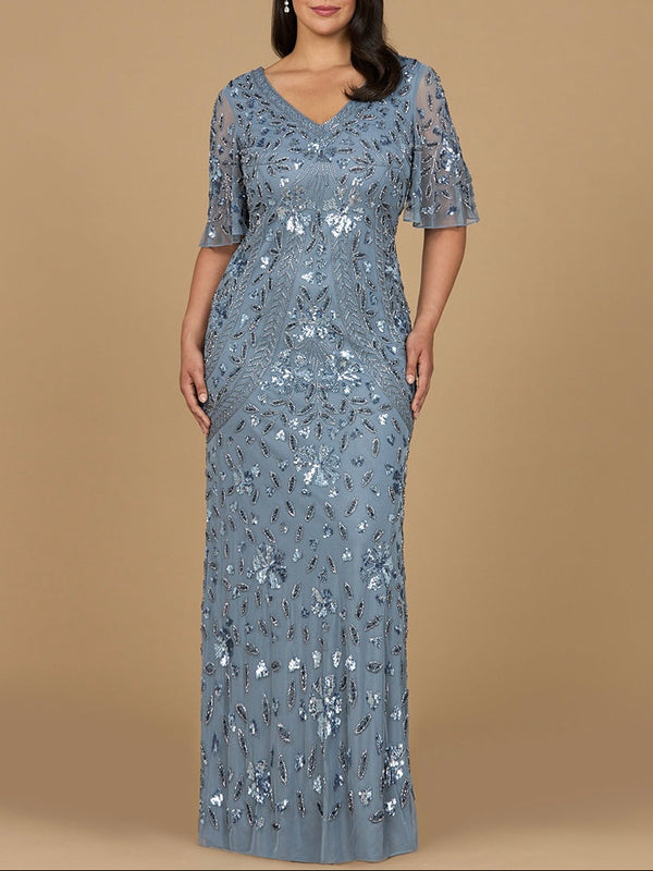 Woman wearing a blue sequin dress against a beige background