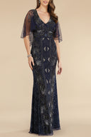 A woman stands against a light background wearing the Lara 29393 Cape Sleeve Beaded Gown, a floor-length navy blue dress with sheer flutter sleeves, silver embroidery, and a deep V neckline—ideal for the mother of the bride.
