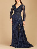 A woman poses against a beige background in the Lara 29620 Lace Skirt Overlay Dress, a floor-length navy gown with long sleeves, a deep V-neckline, intricate beading, and subtle chevron pattern—perfect for a mother of the bride.