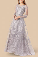 A woman in the Lara 29759 ballgown, featuring long sheer sleeves, intricate floral lace, sparkling full embellishments, a high neckline, and a flowing floor-length skirt.