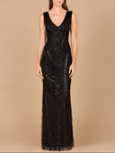 A woman with straight brown hair and a neutral expression poses against a beige background wearing the Lara 33552— a sleeveless, floor-length fitted dress adorned with tonal beading, patterns, and a deep v-neckline.