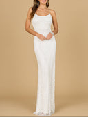 A woman in a white, scoop neck, open back beaded bridal gown with spaghetti straps and a fitted mermaid silhouette.