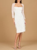 A stunning white dress made of sheer mesh and feathers, highlighting a whimsical and sophisticated style.