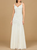 Woman wearing a white evening gown against a beige background
