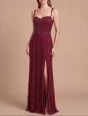 Woman wearing a burgundy evening gown with a slit on a beige background