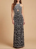 Woman wearing a black and silver patterned evening gown on a beige background
