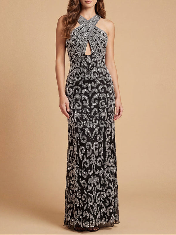Woman wearing a black and silver patterned evening gown on a beige background