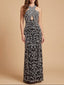 Woman wearing a black and silver patterned evening gown on a beige background