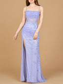 A model poses in a lavender evening gown with a dramatic slit, highlighting a blend of grace and modern fashion.